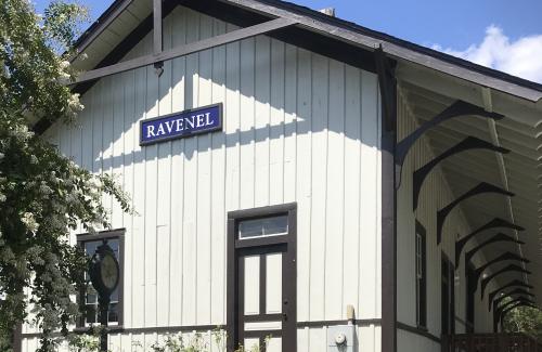 gray and brown train depot with Ravenel sign