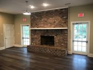Hall interior with fireplace and hardwood floors