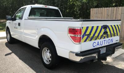 White Town of Ravenel Truck with caution markings on rear