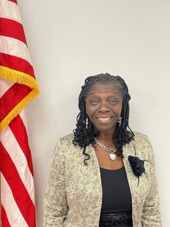 Council Member Cora Singleton by the American Flag