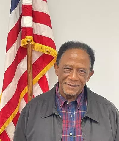Council Member Robert L. Cochran by the American Flag