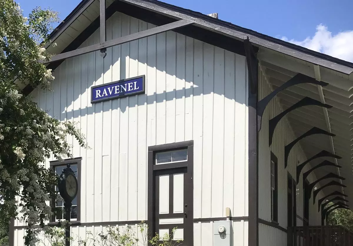 gray and brown train depot with Ravenel sign